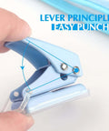 Close-up of a blue mini hole puncher from the Three Piece Mini Hole Puncher Set With Six Sheet Capacity Each For ID Cards Chipboard Arts And Crafts Projects Sweet Value Pack For Home Office School And Studio Use Easy Punching, highlighting lever mechanism.