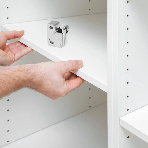 Installing stainless steel cabinet roller catch latches with anticollision beads on a white shelf for handleless access