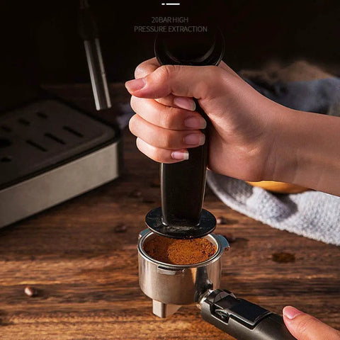 Hand pressing coffee grounds in portafilter for 4 Cup Drip Coffee Maker With Timer And Thermal Carafe Stainless Steel Coffee Brewer