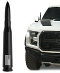 50 Cal Bullet Antenna With American Flag Finish For Ford F150 F250 F350 Super Duty Ford Raptor Bronco Trucks Anti Theft Technology Replacement Accessory And Black Tire Stem Caps next to truck front