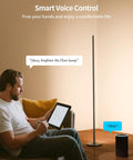 Man using tablet to control Smart Corner Floor Lamp With Alexa And App Control For Hands Free Scene Setting, 16 Million DIY Colors.