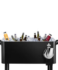 80 Quart Black Rolling Ice Chest Cooler Cart On Wheels For Patio And Backyard Parties filled with drinks and ice