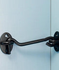 Close-up of Heavy Duty Sliding Barn Door Hardware Kit Includes Two Premium 3 Inch Steel Hook And Eye Latch mounted on a blue door.