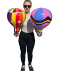 Person holding two multicolor 18 inch inflatable hot air balloons set with 3 designs 3 pack for kids parties