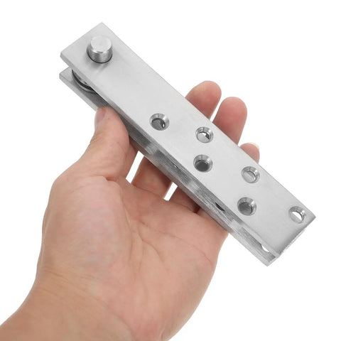 Close-up of a hand holding Hidden Pivot Hinge System For Wooden Bookcase Doors, 360 Degree Stainless Steel Heavy Duty Concealed Upper And Lower Frame Hinges