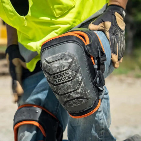 Heavy Duty Hinged Knee Pads With Gel Foam Cushioning for all-day comfort and stability on a worker's knee in use outdoors.