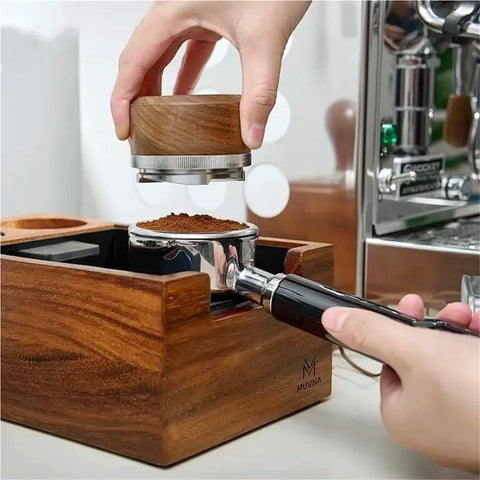 Heavy Duty Wooden Espresso Knock Box With 58mm Tamper Base, user tampering coffee grounds, showcasing dual slot design for home cafe.