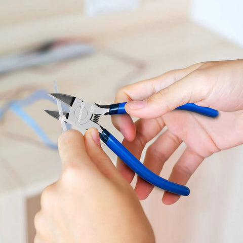 Person using 10 Pack 6 Inch Wire Cutters For Crafting And DIY Projects, blue handle, cutting ribbon with spring-loaded pliers.