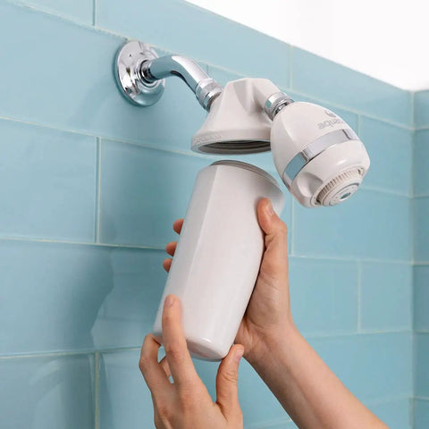 Person installing Shower Water Filter Replacement Cartridge For AQ-4125, twist-in under showerhead, blue tile background
