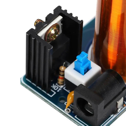 Close-up of Mini Coil Kit Module With LED Light DC 9 To 12V Power Transmission on a compact PCB with components
