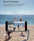 Smooth Mobile Gimbal With Built In Extension Rod capturing video on beach with phone; three-axis stabilizer for Android and iPhone.