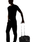 Person holding an Under Seat Carry On Bag With Rolling Wheels For Airline Travel Your Go To 15 Inch Personal Item That Fits Easy Lightweight 4 Lb Case Sized 15 By 9 By 14 Inches With Durable Build And Limited 5 Year Warranty.