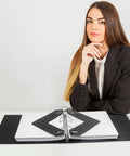 Heavy Duty Triangle Sheet Lifters For Three Ring Binders Kick Paper Curl To The Curb With These Solid Plastic Page Protectors 12 Pack on a desk.