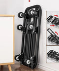 Smooth Rolling Folding Platform Trolley With Durable Steel Frame, Portable Flatbed Cart For No Sweat Household Hauling, Compact Utility Dolly For Garage Storage And Breezy Weekend Project Moving, folded and leaning against a wall.