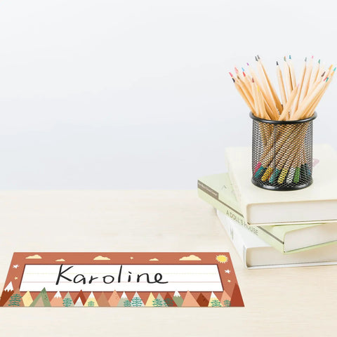 Moving Mountains Desk Nameplates Set Of 30 For Classroom And Office Decor on desk with books, pencils in colorful pattern, 4.1x12.6 inches.