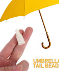Cool DIY Fixers For Your Dinged Umbrellas: 10 Pc Plastic Stick End Caps With Snap Holes Ribs Bone Tips For Weathering Daily Commute And Shading In Style. beige plastic umbrella tip cap on fingers beside yellow umbrella