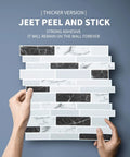 Hands holding Thick 2mm To 2.5mm Peel And Stick Marble Backsplash Tiles 12x12 10 Pack With 3x Stronger Adhesive against a wall.