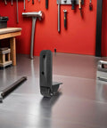 Rock Solid Heavy Duty Non Swivel Casters With L Shape Plate Mount, black caster with smooth PVC rubber wheel on workshop surface.