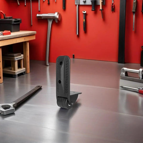 Rock Solid Heavy Duty Non Swivel Casters With L Shape Plate Mount, black caster with smooth PVC rubber wheel on workshop surface.