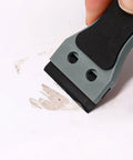 Two Pack Plastic Razor Scraper With Six Inch Long Handle And One Hundred Double Edge Blades, Heavy Duty Adhesive Remover in use on surface