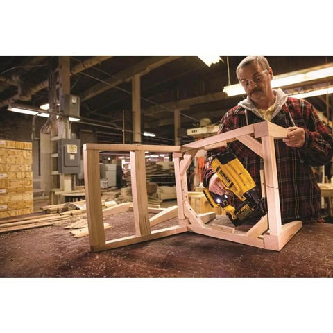 Person using Battery Powered Cordless 18 Gauge Brad Nailer 20V Max XR with Brushless Motor for precise framing.