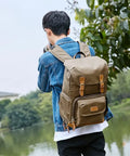 Chic Canvas Camera Backpack for Outdoor Photography with Tripod Holder, worn by man in nature. Large capacity, water resistant.