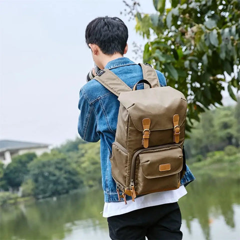 Man wearing Chic Canvas Camera Backpack For Outdoor Photographers With Large Capacity Anti Shock Padded Interior in nature