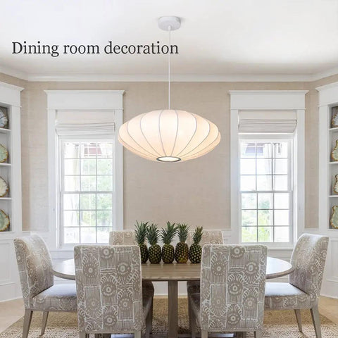 Italian Silkworm Cocoon Pendant Light With White Faux Silk Drum Shade in dining room setting, hanging above table