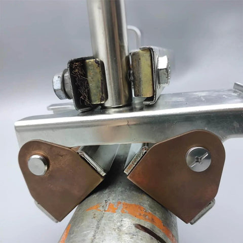 Close-up of Hi-Temp Grounding Magnetic V-Pad With Pure Copper Contact For Welding Fixtures And Grounding, attached to metal pipe
