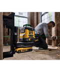 20V Max Laser Level Kit With Cross Line And 3x360 Green Beams in use on construction site, worker leveling drywall
