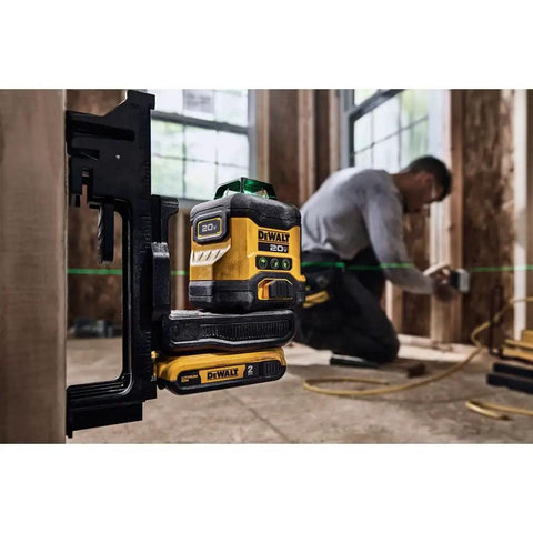 20V Max Laser Level Kit With Cross Line And 3x360 Green Beams in use on construction site, worker leveling drywall