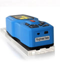 Heavy Duty Digital Handheld Surface Roughness Tester With Slick OLED Screen and Precise Point Zero Zero One Measurement Precision on clear base.