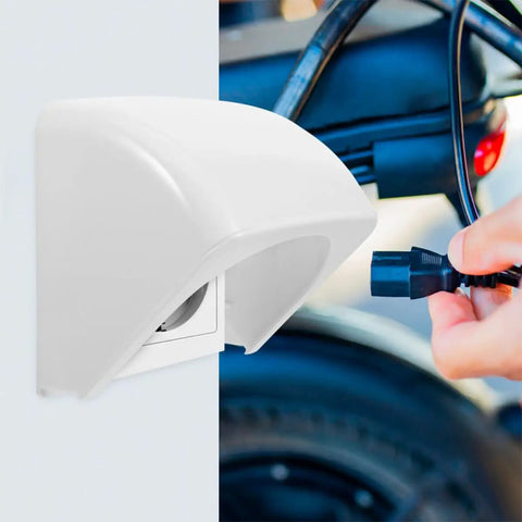 2 Piece Weatherproof Outlet Boxes Tough As Nails ABS Wall Plug Covers Socket Rain Shield mounted on wall with plug in hand.