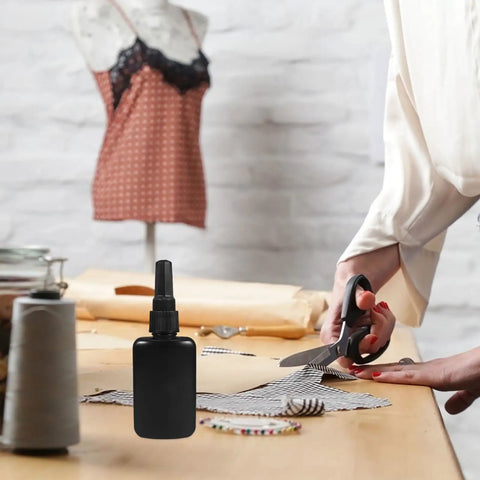 Solid Black 50ml H Dpe Sealed Dropper Bottles Kit Perfect For Industrial Glue Dispensing And Diy Craft Projects With Thickened Plastic Fine Tips For Smooth Pouring Every Time on a crafting table.