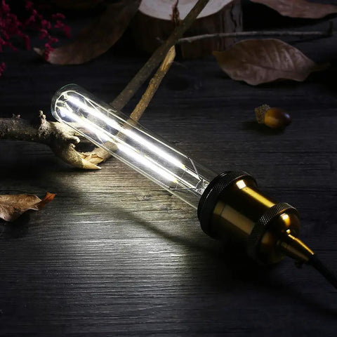 Dimmable T10 LED Filament Tubular Bulb 4000K Daylight White, 6W Edison Style, E26 Base glowing in a dark setting
