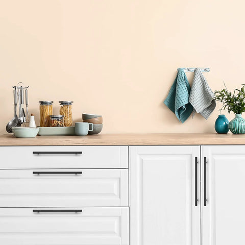 Kitchen scene with Matte Black 10 Inch Square Cabinet Pulls, 5 Pack on white cabinets, showcasing modern hardware for homes and offices