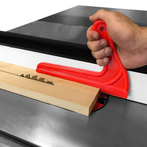 Hand using a red V-type push stick on a table saw with wood, part of the 4Pcs Safety Push Sticks for Woodworking set.