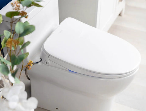 Top Shelf Elongated Bidet Toilet Seat Crisp White with adjustable nozzle and heated cushion in modern bathroom