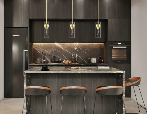 Modern Brass Pendant Light Over Kitchen Island With Clear Glass Shade in a sleek kitchen setting, adjustable rods visible