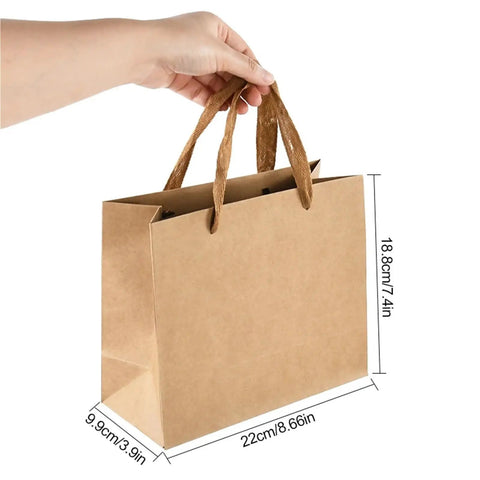 Hand holding Kraft Paper Gift Bags Set Of 20 For Birthday Bashes And Weddings, Great For Guest Favors, with size measurements.