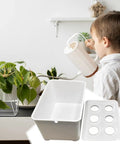 Child with white watering can and Six Hole Hydroponics Grow Box Kit For Indoor Outdoor Garden Soilless Cultivation System