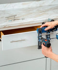 Person using Cabinet Hardware Jig And Pull Drill Guide Pro For Easy Install on a kitchen drawer for precise handle alignment.