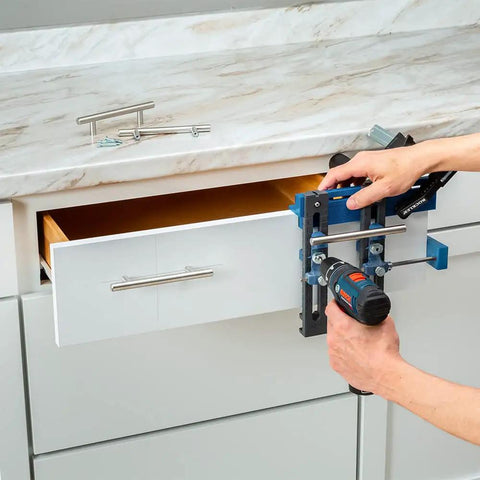 Person using Cabinet Hardware Jig And Pull Drill Guide Pro For Easy Install on a kitchen drawer for precise handle alignment.