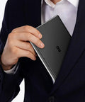 Person placing Pocket Sized Handheld Laptop Boosted By A Slick Seven Inch Display Running Windows 11 Home into suit pocket.