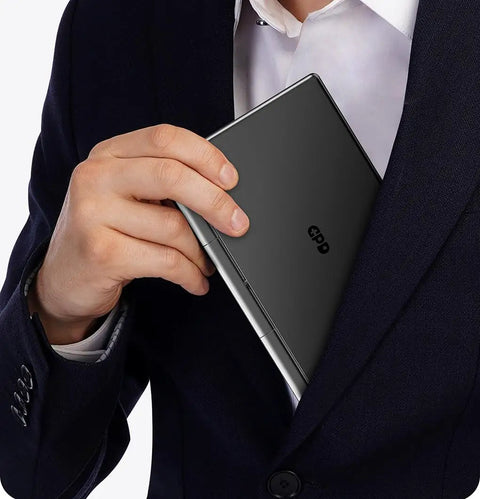 Person placing Pocket Sized Handheld Laptop Boosted By A Slick Seven Inch Display Running Windows 11 Home into suit pocket.
