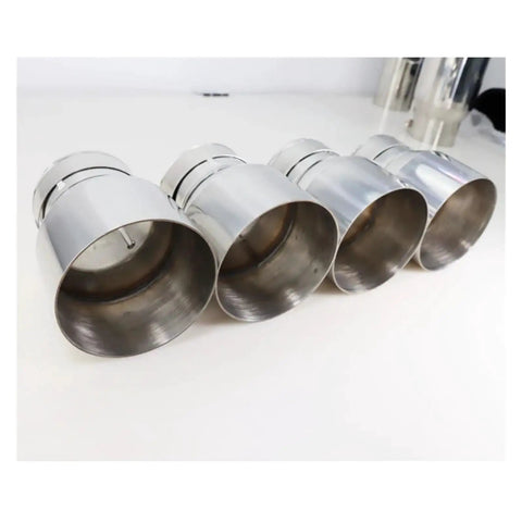 BMW Stainless Steel Exhaust Tips 4 Piece Direct Fit Set For M2 M3 M4 F87 F80 F82 F83 Level Up Your Ride With Sick Style Sound And Protection Durable Tailpipe Guard Against Rain Dust And Debris, showing four shiny metal exhaust tips from side angle.