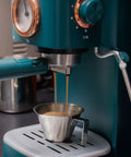 Go-To Stainless Steel Espresso Cup With Handle 3.4oz 100ml pouring espresso from machine with V-shaped mouth and spout