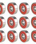 Twelve 608-2RS steel ball bearings with red double rubber seals, front view, 8x22x7 mm.