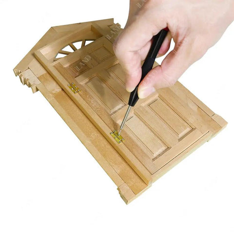 Top Tier 1/12 Scale Dollhouse Accessories Kit With Legit 700 Pieces Of Mini Knobs Hinges Handles And Locks Plus Screws And Screwdriver showing a hand installing a hinge on a wooden dollhouse door.