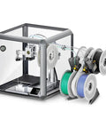 Transparent Acrylic 360 Degree 3D Printer Enclosure With LED Lighting and Stable Temperature Control next to filament spools, A1 Series compatible.